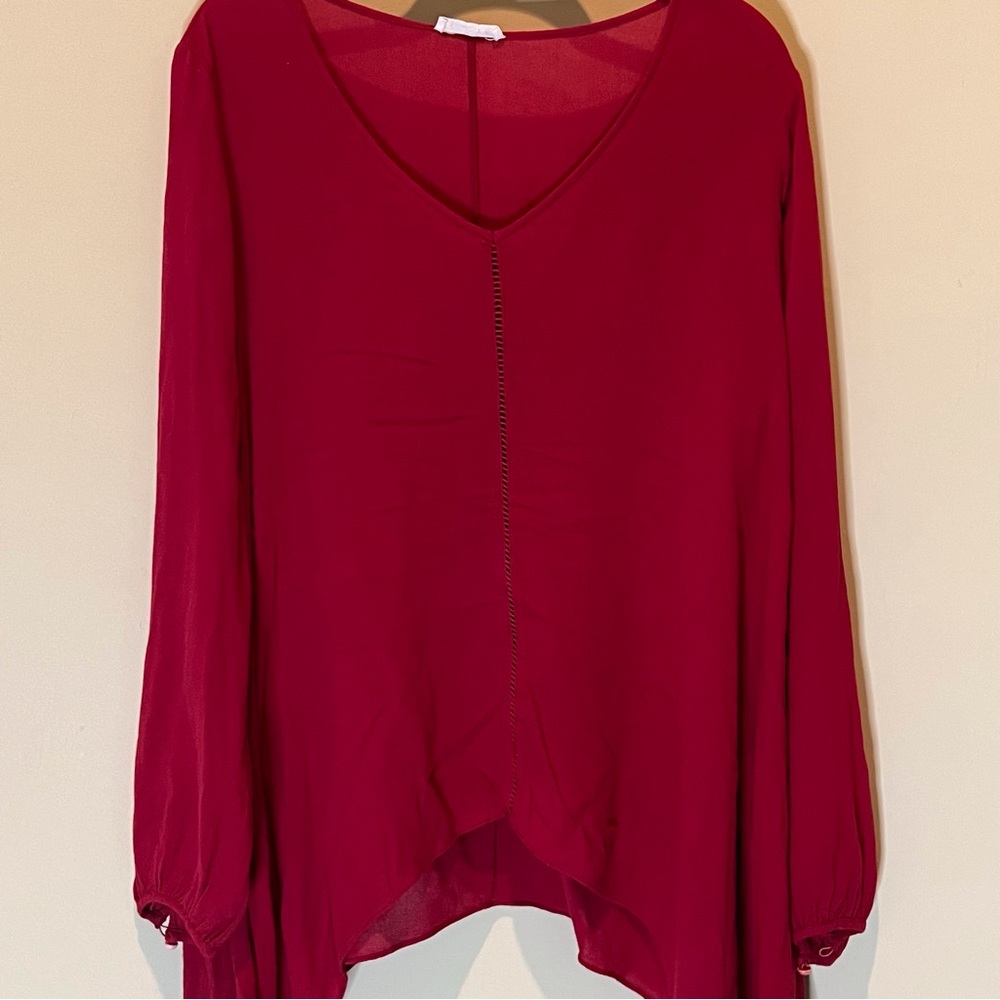 Really cute, light and flowing red v-neck top with longer sides.